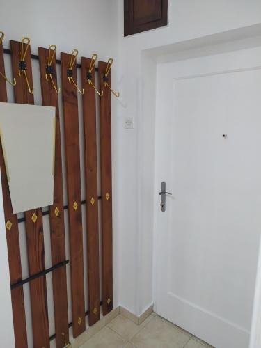 a room with a door with a bunch of wooden panels at Apartman Mali Raj Rudnik II in Rudnik Kačerski
