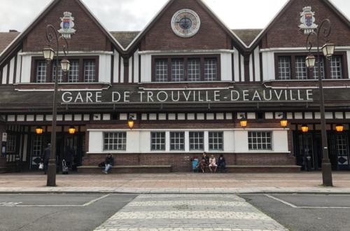 a building with people standing outside of it at Hotel des Sports in Deauville