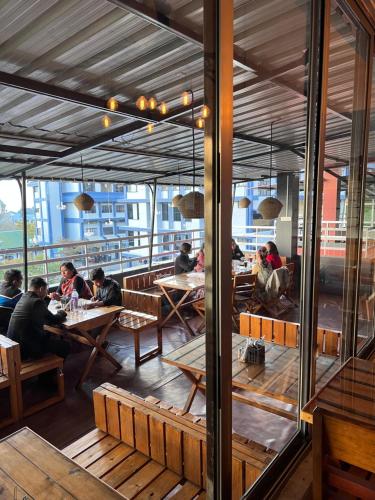a group of people sitting at tables in a restaurant at The Living Roof in Shillong
