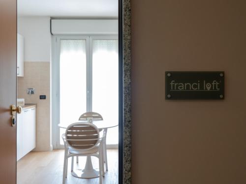 a mirror reflecting a table and a chair in a room at Franci Loft in Pescara