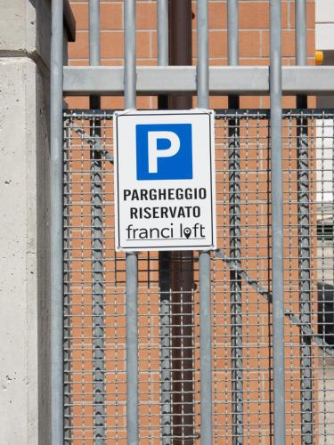 a parking sign attached to a metal fence at Franci Loft in Pescara