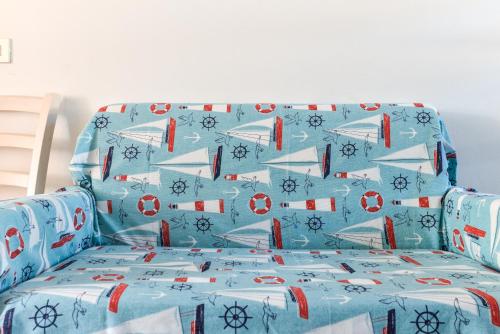 a blue couch with a bed in a room at Il Quadrifoglio 3 in Procchio