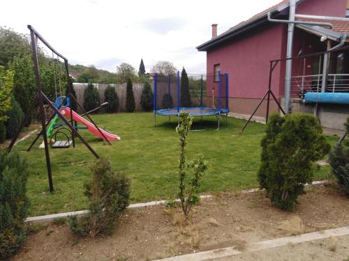 a yard with a swing set and a playground at Vila Viktori in Pirot