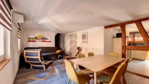 une salle à manger et un salon avec une table et des chaises dans l'établissement Le Nature d'Eguisheim, à Eguisheim