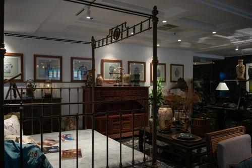 a bedroom with a canopy bed and a table at Amanaki Thao Dien in Ho Chi Minh City