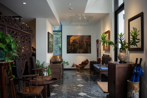 a room with tables and chairs and some plants at Amanaki Thao Dien in Ho Chi Minh City