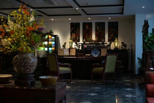 a room with a table and chairs and a vase of flowers at Amanaki Thao Dien in Ho Chi Minh City