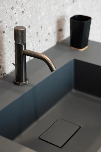 a kitchen sink with a faucet on a counter at Lisetta Gardens Boutique & Suites in Cisternino