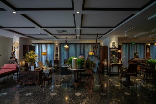 a living room with a couch and tables and chairs at Amanaki Thao Dien in Ho Chi Minh City