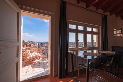 a room with a balcony with a view of the city at Homie Suites - Turna Residences in Cihangir in Istanbul
