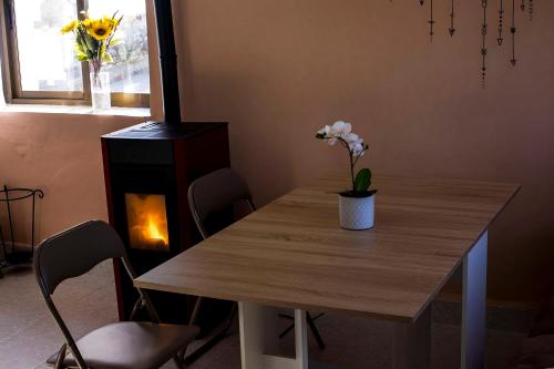 a dining room table with a fireplace and flowers on it at Vivienda rural Minas Home in Olleros de Sabero