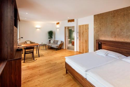 a bedroom with a bed and a living room at City-Hotel Ochsen in Zug