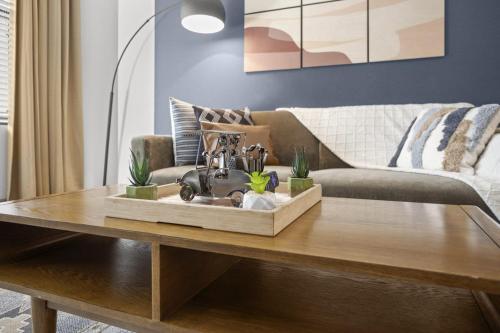 a coffee table in a living room with a couch at Modern 2BR CozySuites on Town Lake waterfront 03 in Tempe