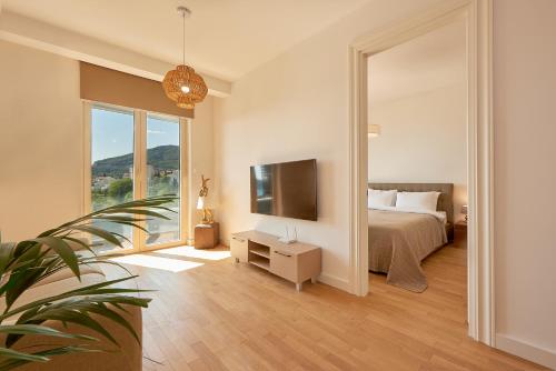 a bedroom with a bed and a tv and a mirror at Skyline resort in Bečići