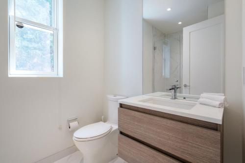 a bathroom with a toilet and a sink and a window at Georgetown 1BR w bike storage nr Waterfront WDC-89 in Washington