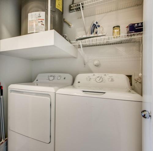 a laundry room with a washer and dryer at Astonishing CozySuites on I-35 with pool&parking #10 in Pflugerville