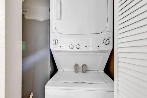 a white washer and dryer in a refrigerator at Breathtaking 2BR Condo w Floor-to-Ceiling Windows Overlooking Ocean in Myrtle Beach