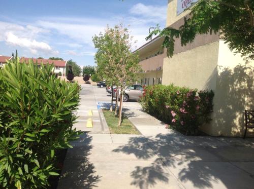 a street in front of a building with a parking lot at America Inn & Suites in Ridgecrest
