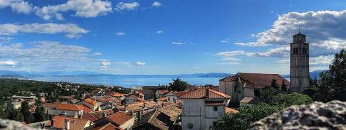a view of a city with a clock tower at Apartments Villa Bare in Kastav