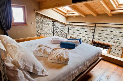 a bedroom with a large white bed with pillows at Narciso Home in Adrara San Rocco