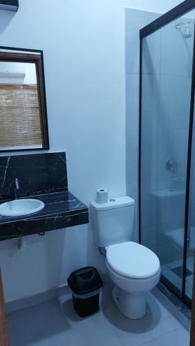 a bathroom with a toilet and a sink and a shower at Casa de Mia in Asuncion