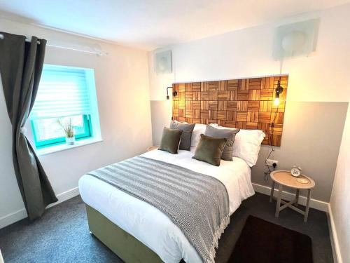 a bedroom with a large bed and a window at The Old Bakery in Cheltenham