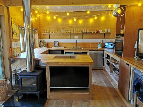 a kitchen with wooden counters and a stove in it at The Base Vegan Retreat Animal Sanctuary in Bristol