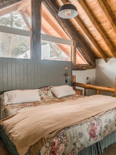 a bedroom with a bed with a large window at Cumbres Del Martial in Ushuaia