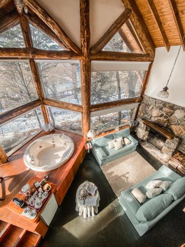 an attic room with a tub in a tree house at Cumbres Del Martial in Ushuaia