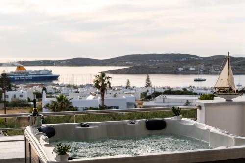 a bath tub on a balcony with a view of a harbor at Panos Villa Sunset View in Parikia