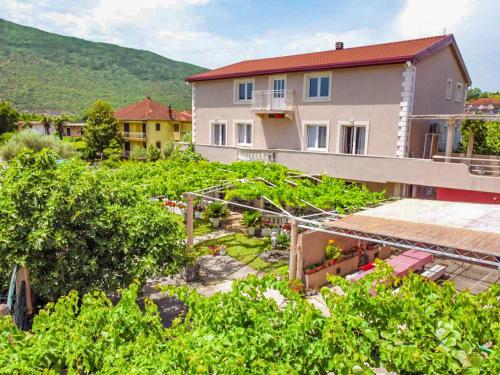 a view of a house and a vegetable garden at Apartments Al Parma in Budva