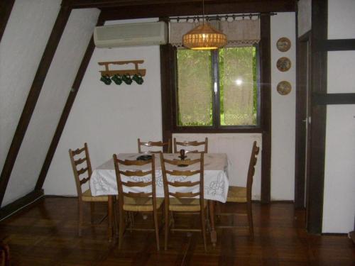 a dining room with a table and chairs and a window at Holiday home Mir - countryside house with jacuzzi in Krapje
