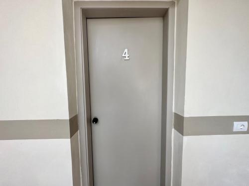 a door with the number four on it at Center Rooms in Piacenza