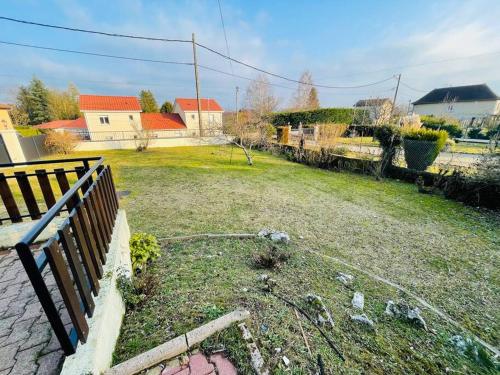 a yard with a fence and a field with houses at Green Gables- Old Charm in Vézeronce