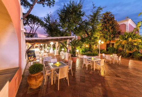 a restaurant with tables and chairs on a patio at Hotel San Valentino Terme in Ischia