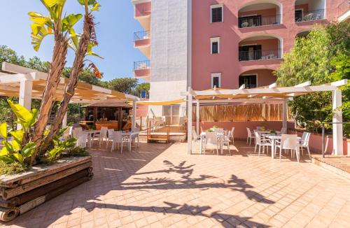 a patio with tables and chairs in front of a building at Hotel San Valentino Terme in Ischia