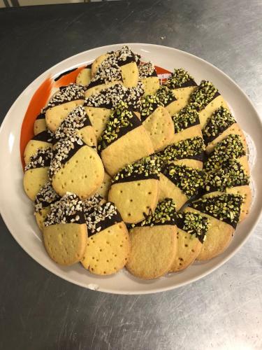 a plate of cookies with sprinkles on a table at Hotel Vernel in Rimini