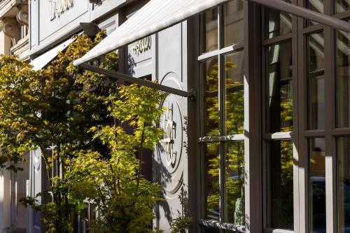 a clock on the side of a building at Hotel Clément in Paris