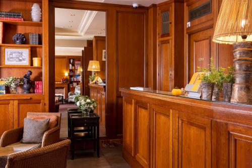 a lobby with a bar with a table and chairs at Hotel Clément in Paris