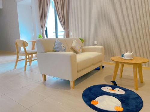 a living room with a couch and a table at Mutiara Melaka Beach Resort by Minso in Tangga Batu