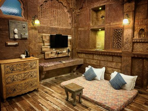 a living room with a couch and a tv in a room at Rani Mahal in Jodhpur