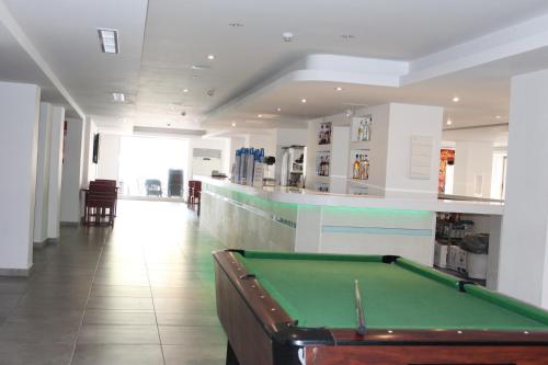 a pool table in a room with a bar at Seramar Hotel Luna Park Adults Only in El Arenal