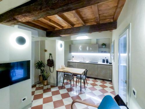 a kitchen and dining room with a table and chairs at Palazzo Scappi Gardi Luxury Apartments in Bologna