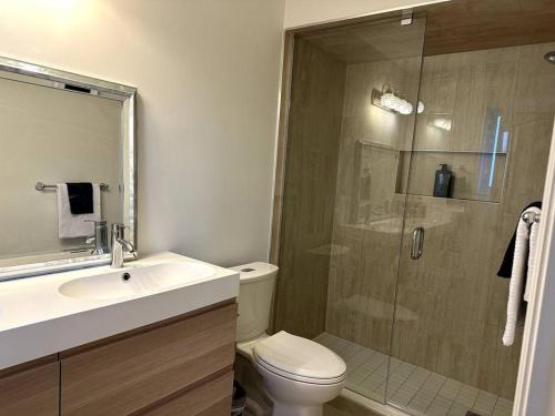 a bathroom with a shower and a toilet and a sink at Beautiful townhouse. in Vaughan