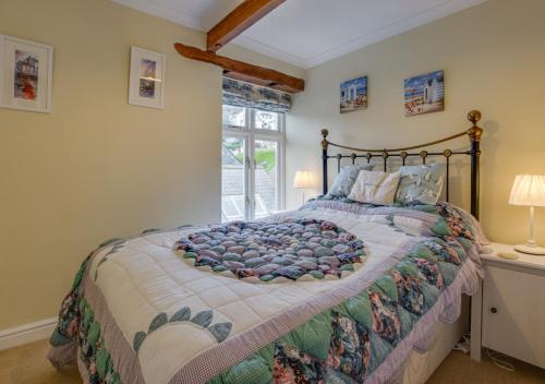 a bedroom with a large bed and a window at 4 Apartment Pixies Holt in Looe