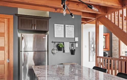 a kitchen with a stainless steel refrigerator and a counter at 34- Chalet à louer à Stoneham in Stoneham
