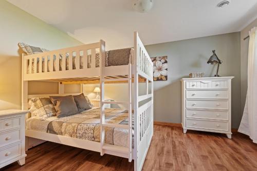 a bedroom with a white bunk bed and a white dresser at 34- Chalet à louer à Stoneham in Stoneham
