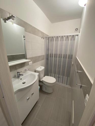 a white bathroom with a toilet and a sink at Affittacamere La Casa Dei Nonni in Polizzi Generosa