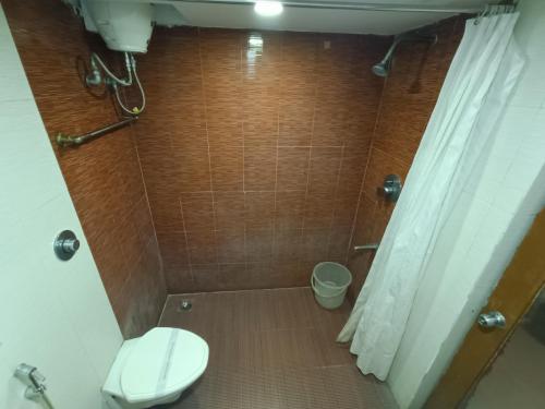 a bathroom with a toilet and a shower at GT Grande Hotel-Near US Consulate in Chennai