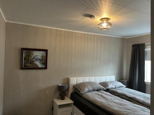 a bedroom with a bed and a ceiling at The Painter's house with view and balcony in Siglufjörður